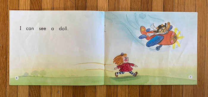 Page spread from predictable book showing airplane pilot looking at a doll