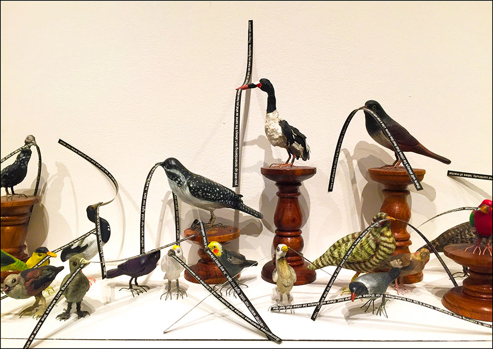 Museum exhibition of birds and their beaks Museum exhibition of birds holding descriptions of their beaks