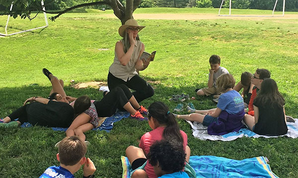 Reading aloud with a group outdoors