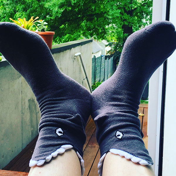 close-up of woman's feet wearing shark socks