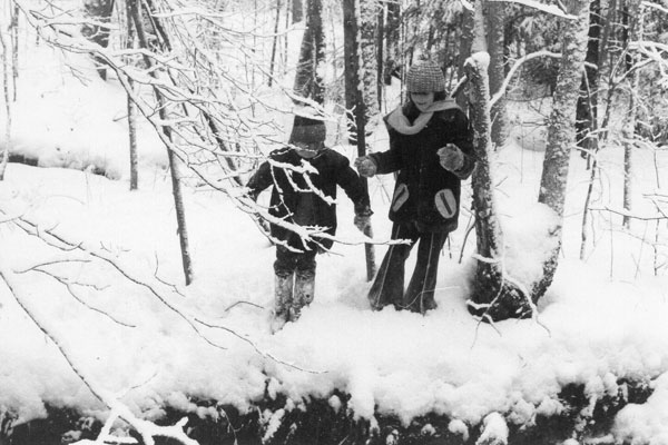 Rachael and Evan exploring in the snowy woods