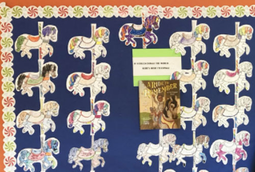 bulletin board display of carousel horses with students’ messages