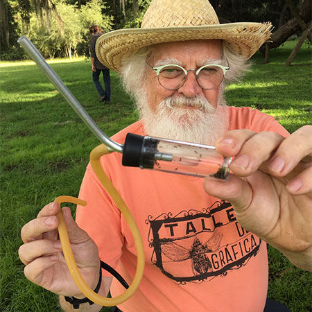 Children's science picture book author Kevin McCloskey collecting ants in a glass tube