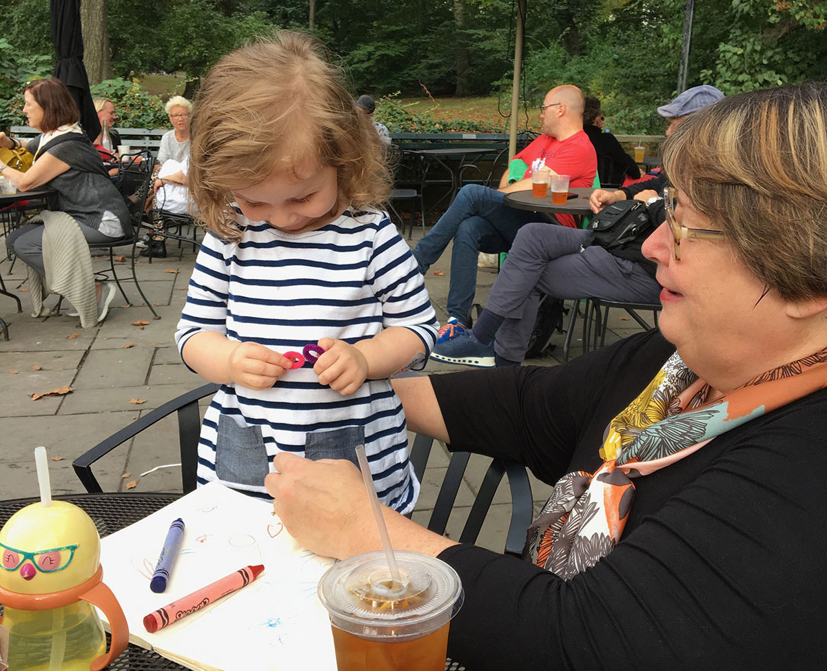 Grandmother and granddaughter drawing outside together