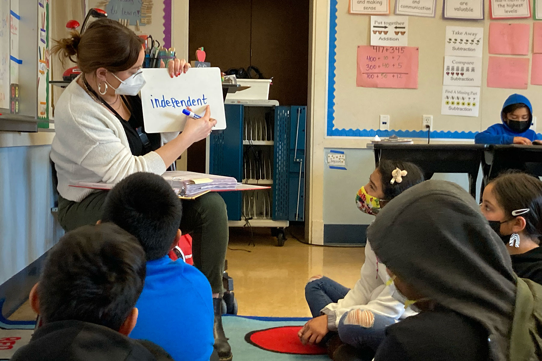 Elementary teacher teaching a multisyllable word to small group of students