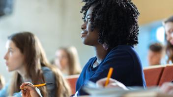 Black college student listening attentively in class