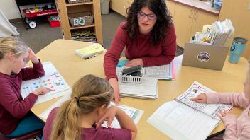 Elementary teacher providing small-group reading instruction