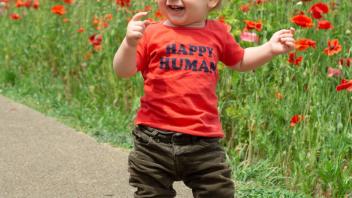 Toddler wearing tee-shirt that says "Happy Human"