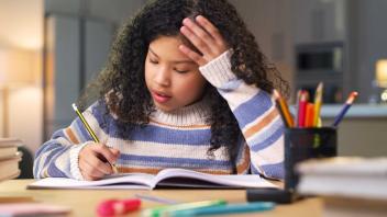 Latina child writing at home